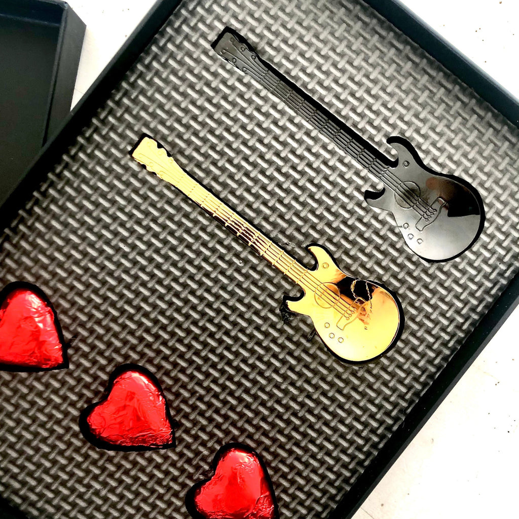 Gold guitar spoon and black guitar spoon